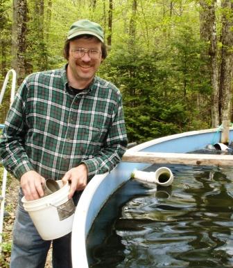 Curt beside a trout tank